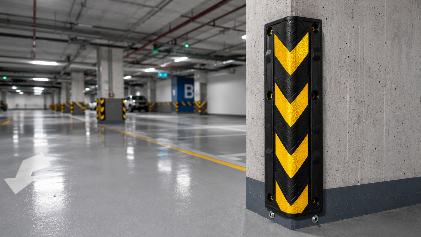 Auroguard heavy duty black rubber corner guard with yellow reflective chevrons mounted securely to a concrete structural column edge